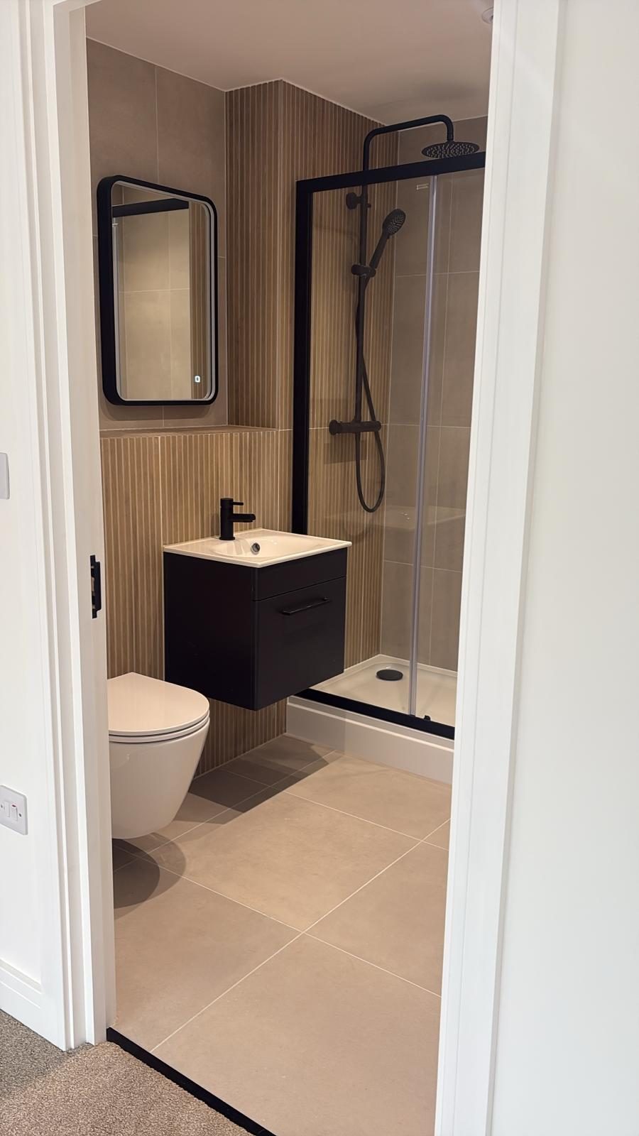 Finished apartment bathroom with black fittings