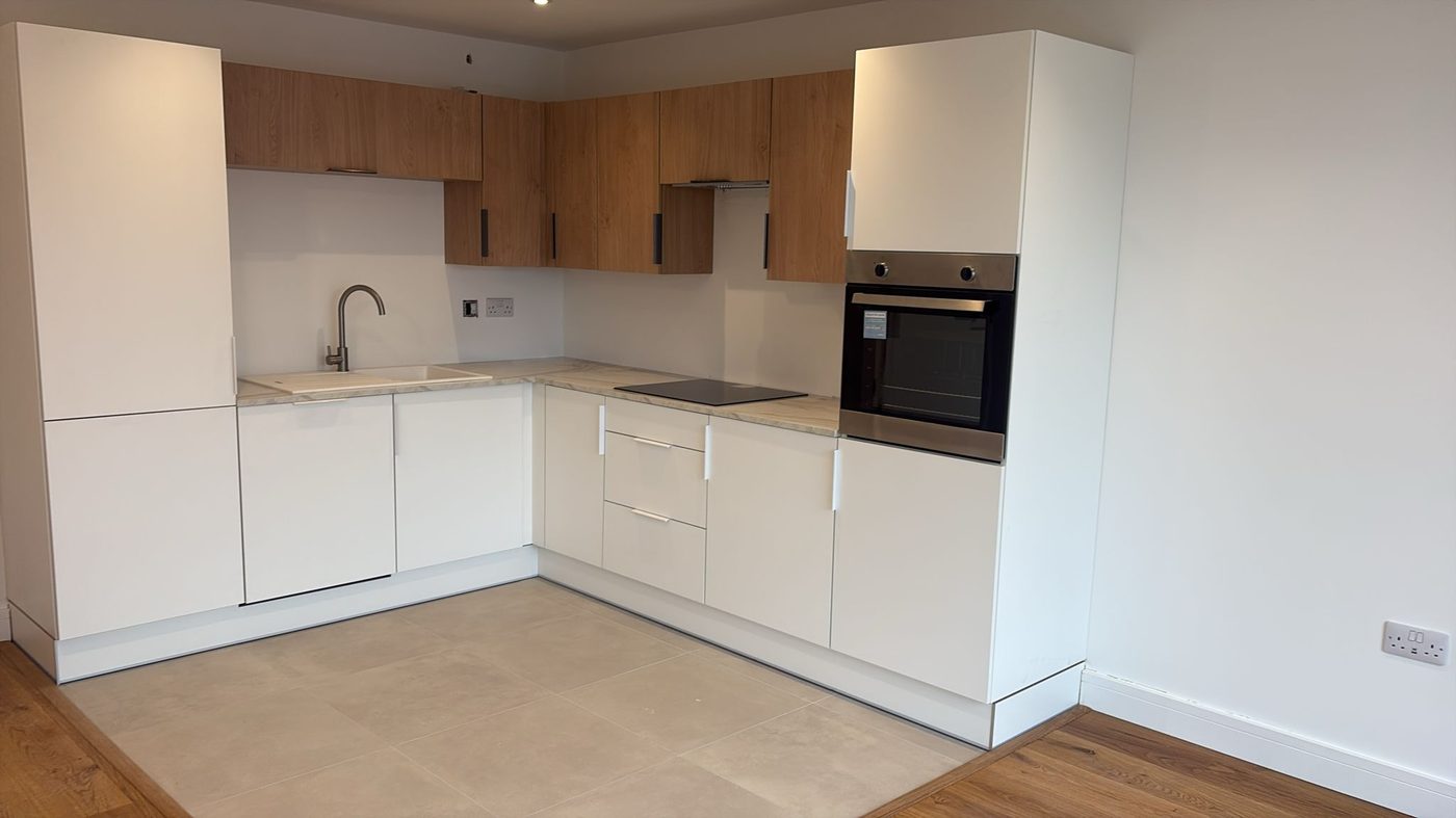 Finished apartment kitchen with wood effect cabinetry