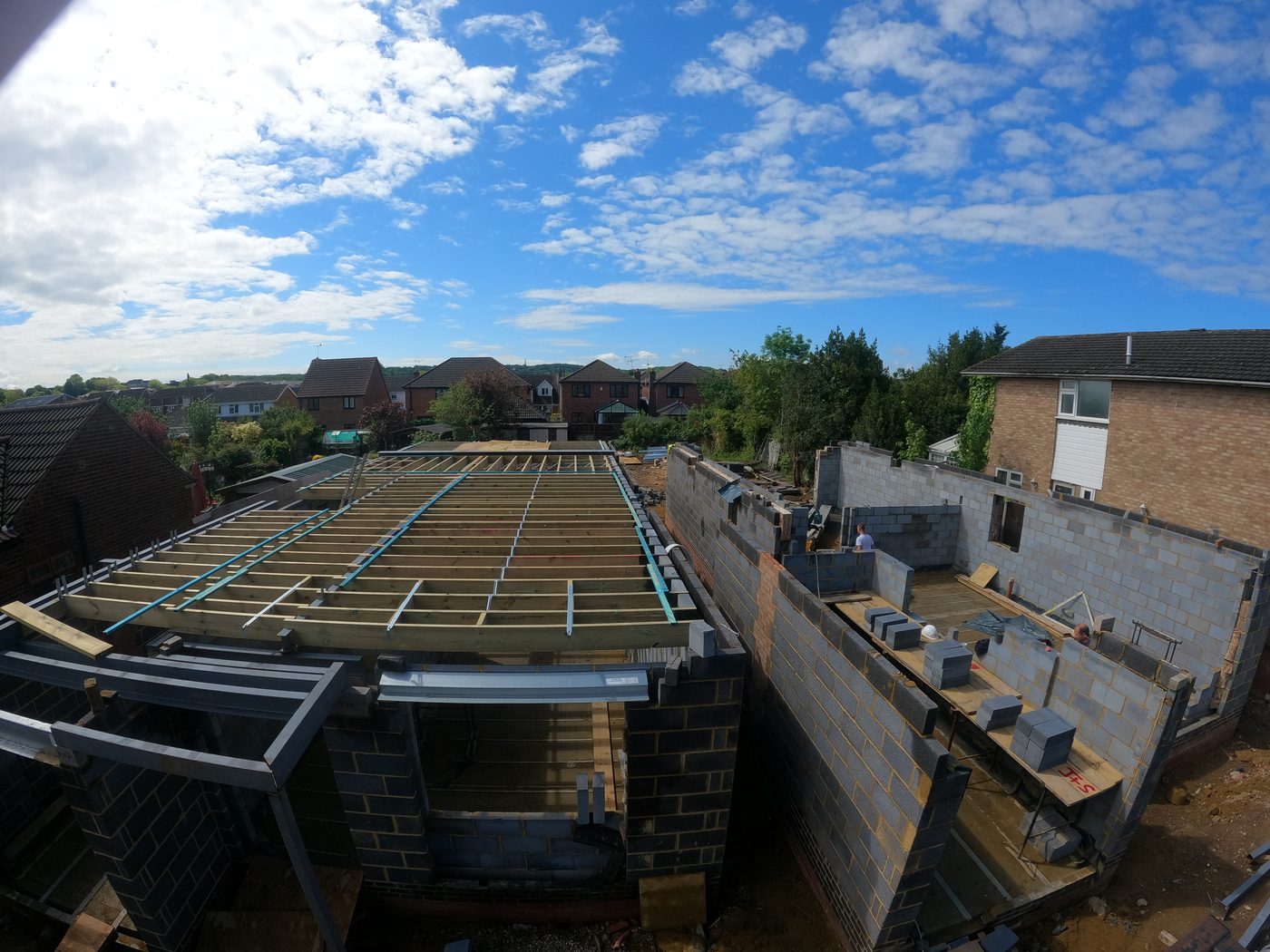 Timber roof structure being built on a house extension