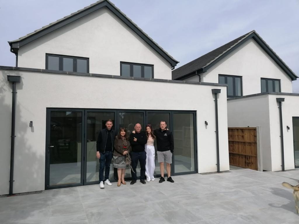 The James and Sons family outside a newly completed development