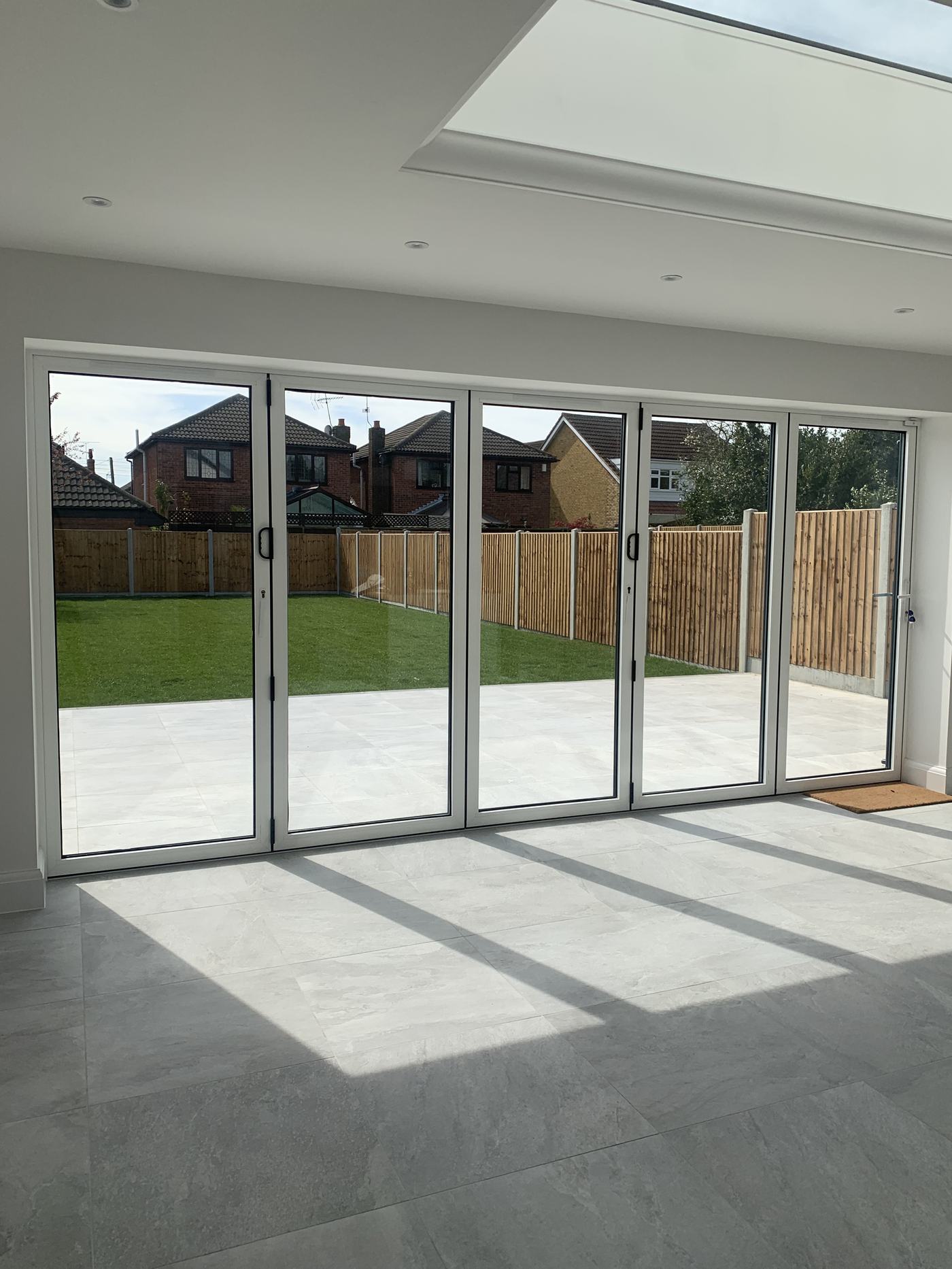 Bi-fold doors opening onto a newly landscaped garden