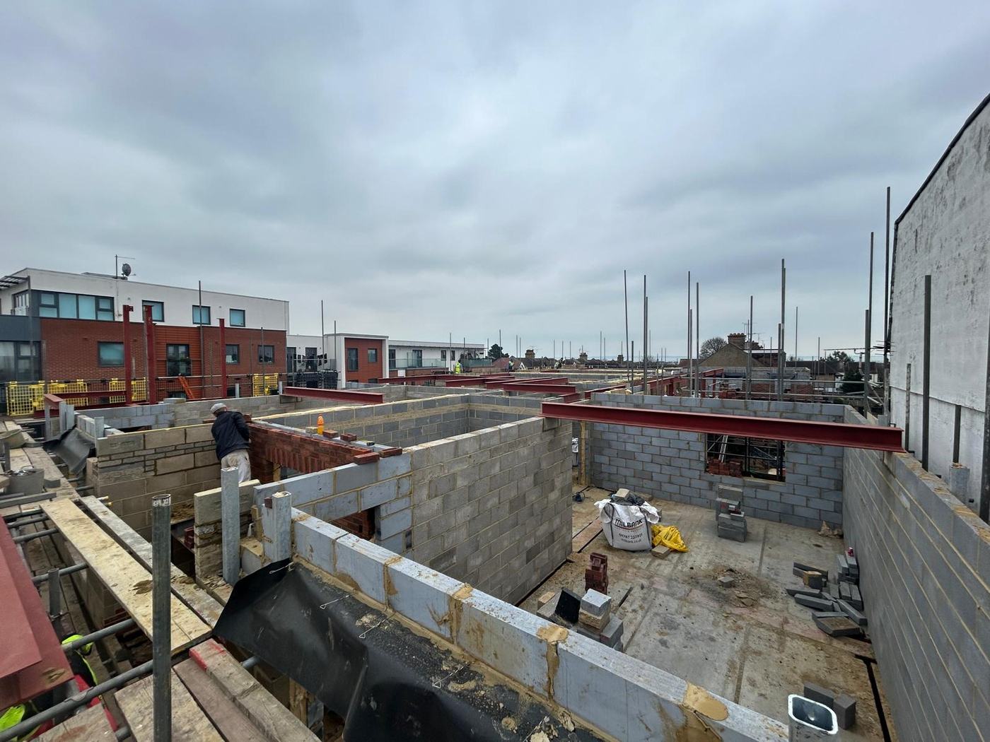 Blockwork walls with steel beams overhead on a construction site