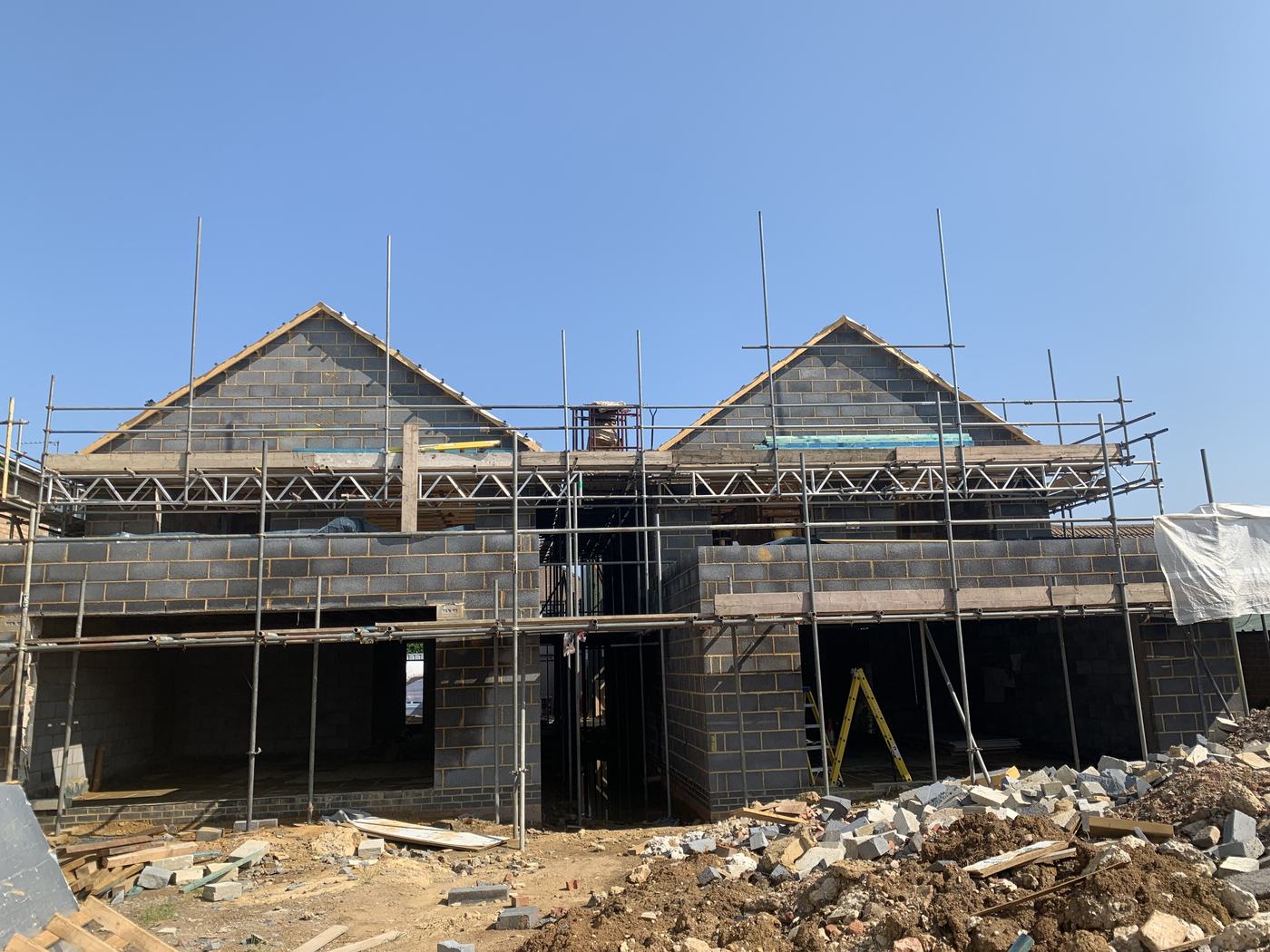 Two new build houses under construction with scaffolding